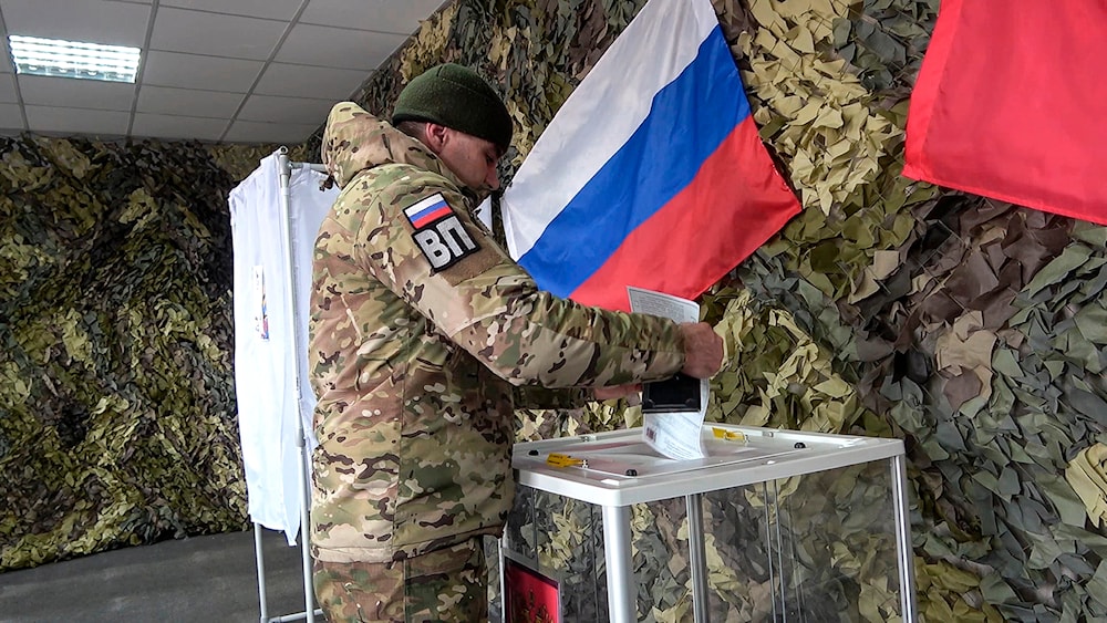 Image taken from a video released by the Russian Defense Ministry Press Service on Monday, March 11, 2024, a Russian serviceman votes in the Zaporizhzhia region, eastern Ukraine.(AP)