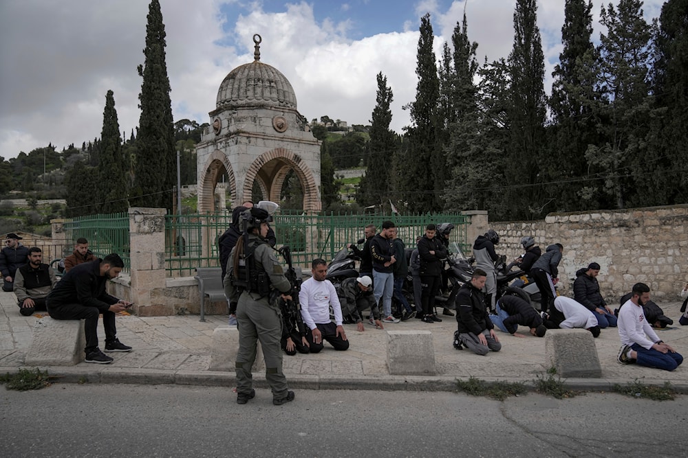 Palestinian Muslim worshipers who were prevented from entering the al-Aqsa Mosque compound, pray outside al-Quds' Old City, Friday, March 8, 2024. (AP)