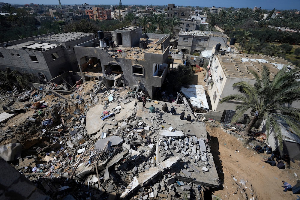Palestinians look at destruction after an Israeli airstrike on a residential building of the Ganan family in Deir al-Balah, Gaza Strip, Thursday, March 7, 2024. (AP)