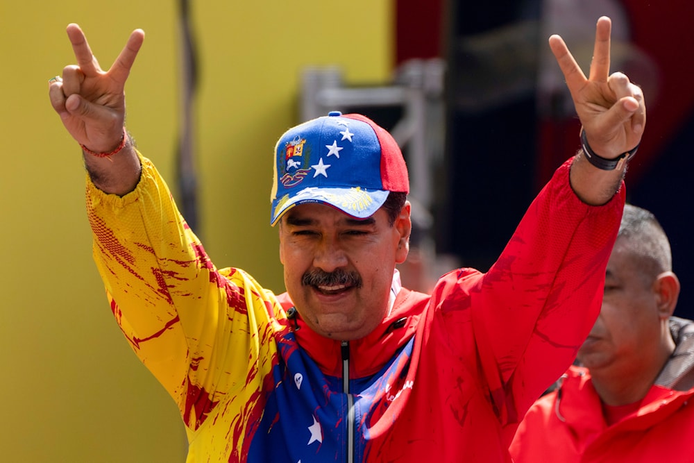 President Nicolas Maduro flashes victory signs during an event commemorating a 2004 speech by the late President Hugo Chavez, in Caracas, Venezuela, Feb 29, 2024.(AP)
