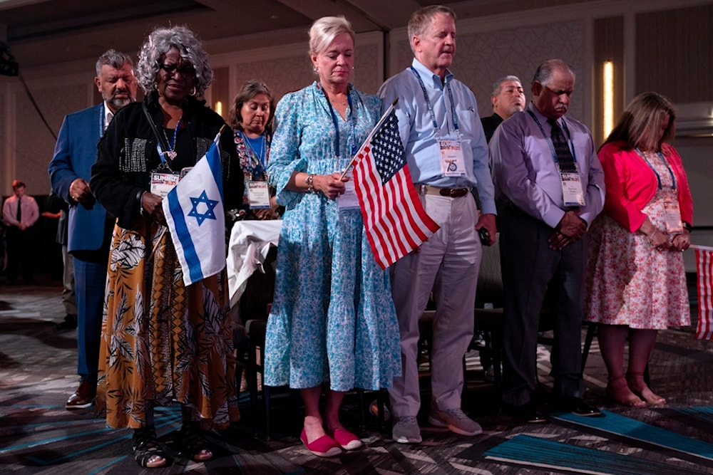 Holding US and Israeli flags, a crowd of largely Evangelical Christians pray during the Christians United For Israel (CUFI) 'Night to Honor Israel' during a summit, on July 17, 2023, in Va, US. (AP)