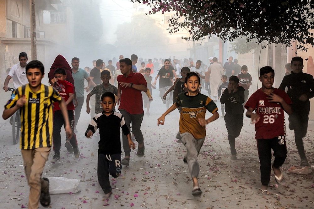 Palestinian children run as they flee from Israeli bombardment in Rafah, Gaza, on November 6. (AFP/Getty Images)