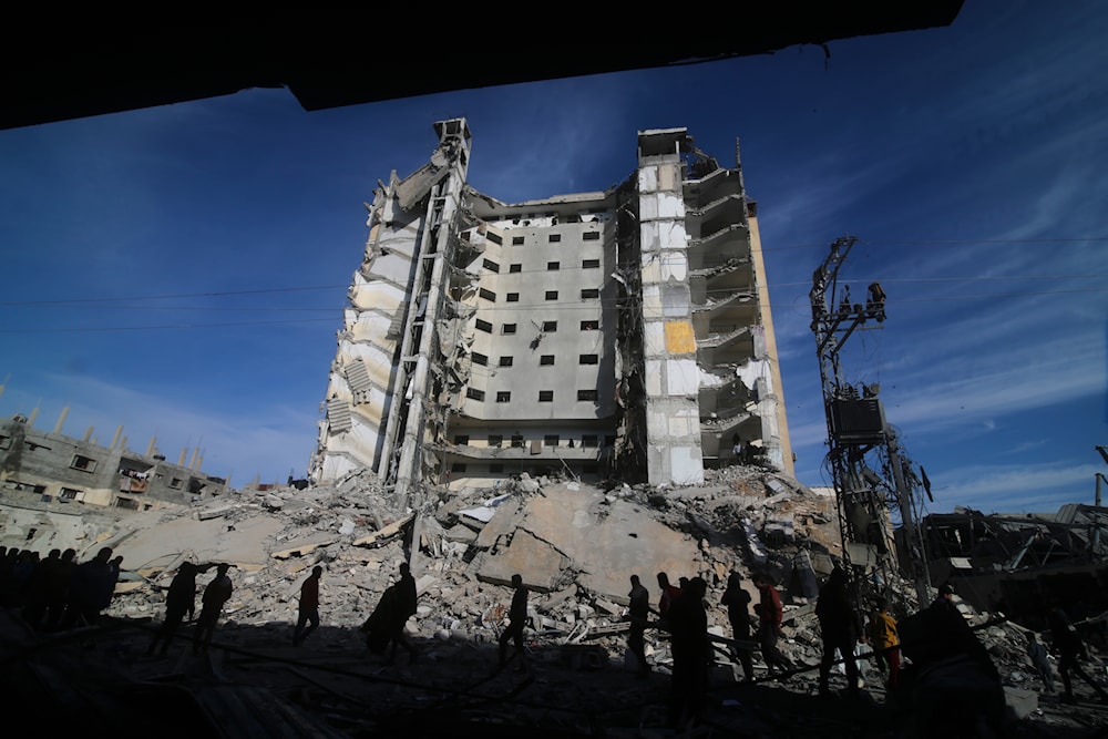 Palestinians walk by a residential building destroyed in an Israeli strike in Rafah, Gaza Strip, Saturday, March 9, 2024. (AP)