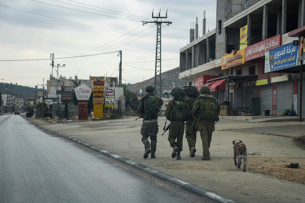 Israeli forces in the flashpoint Palestinian town of Hawara in the Occupied West Bank on Nov. 12, 2023 (AP)