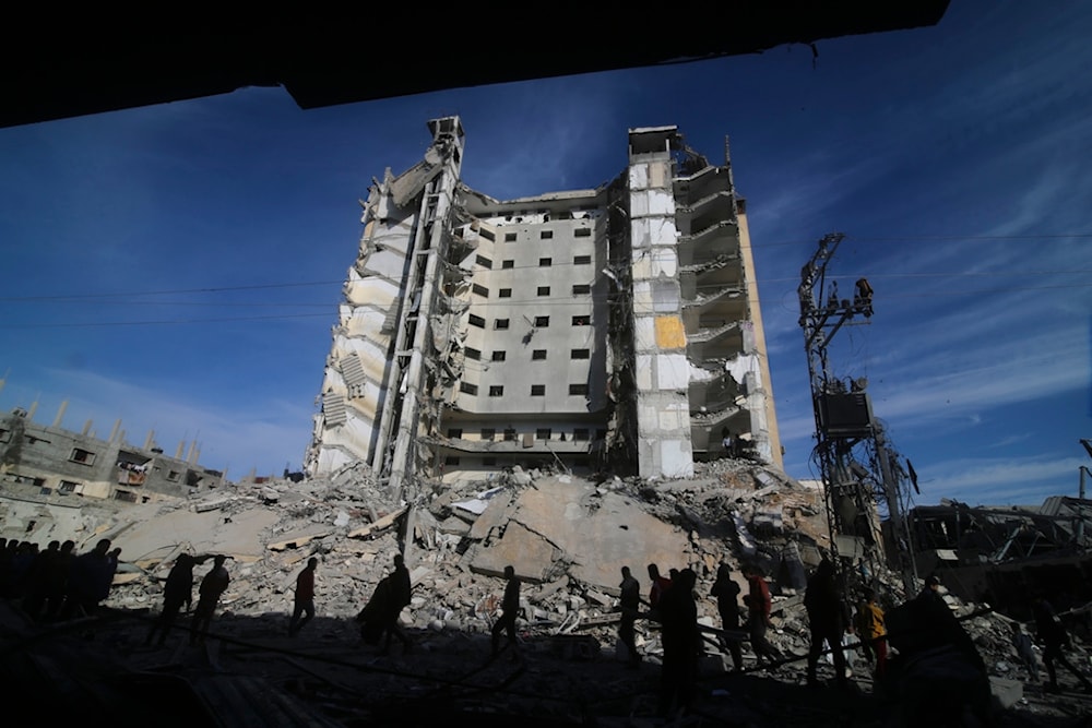 Palestinians walk by a residential building destroyed in an Israeli strike in Rafah, Gaza Strip, Saturday, March 9, 2024. (AP)