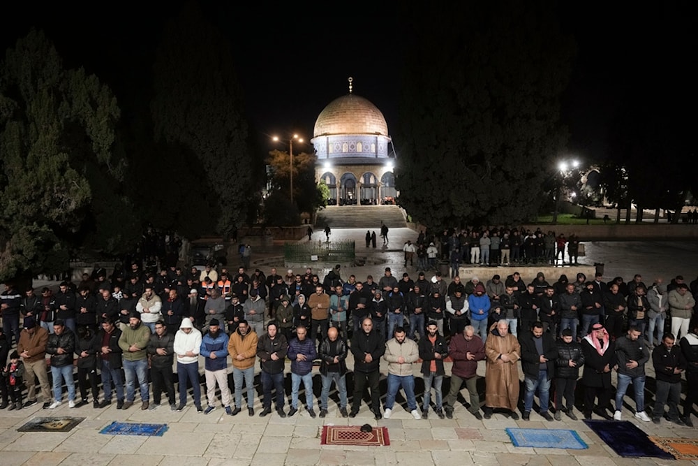 Muslim worshippers perform Taraweeh, an extra lengthy prayer held during the Muslim holy month of Ramadan at the Al-Aqsa Mosque compound in the Old City of al-Quds, Sunday, March 10, 2024. (AP)