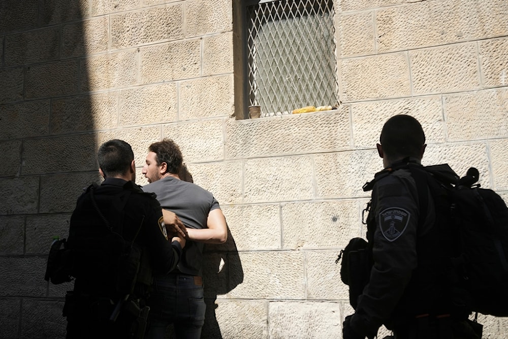 Israeli occupation forces detain a Palestinian in the Old City in al-Quds, Friday, Oct. 13, 2023. (AP)