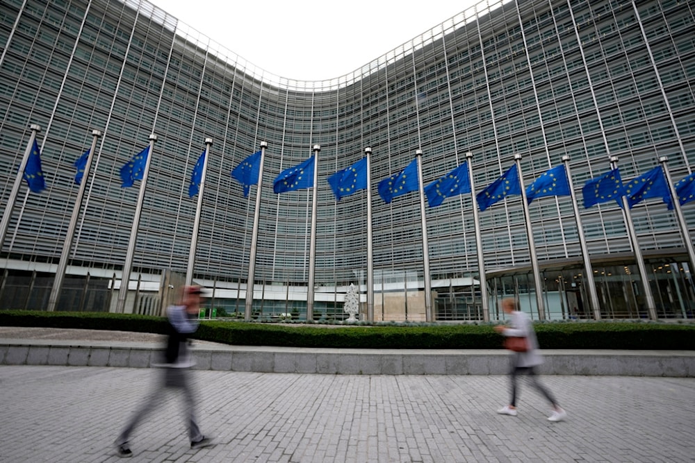 European Union flags wave in the wind as pedestrians walk by EU headquarters in Brussels, on Sept. 20, 2023. (AP)