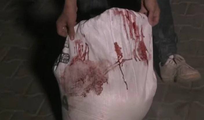 The blood of one of the deceased from the Kuwait Roundabout massacre in Gaza on a bag of flour on March 14, 2024. (Social Media)