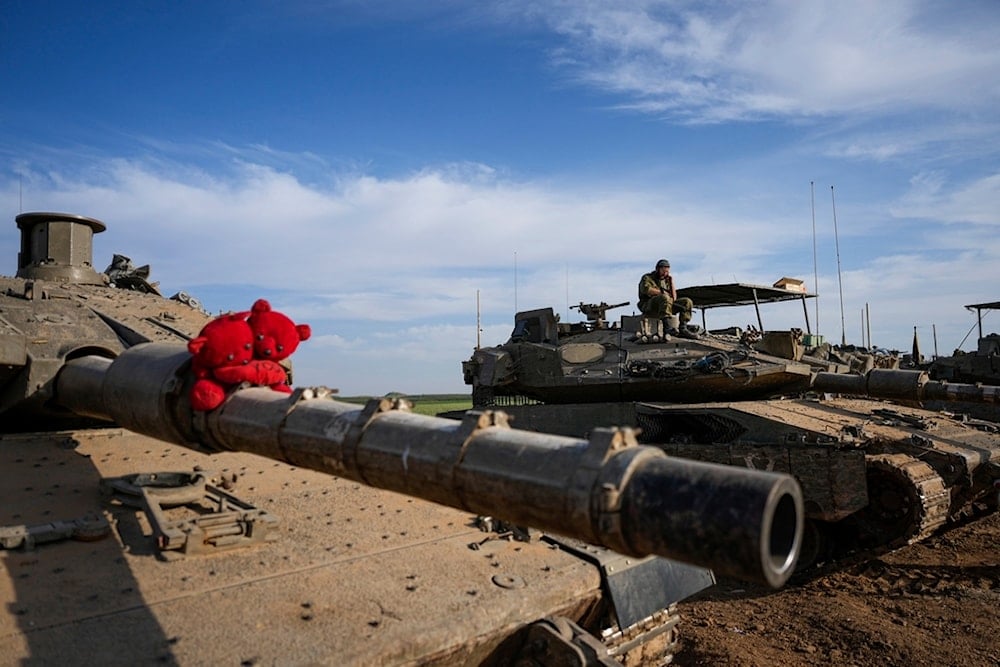 Israeli occupation tanks parked in a staging area near the Gaza Strip border in southern occupied Palestine, Thursday, March 14, 2024. (AP)