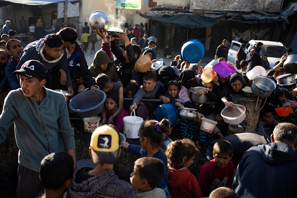 Palestinians line up for a free meal in Rafah, Gaza Strip, on Tuesday, March 12, 2024. (AP)