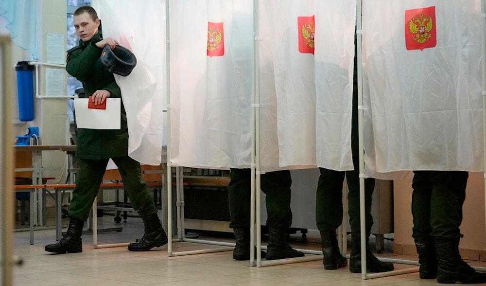A Russian serviceman leaves a voting booth at a polling station during a presidential election in St. Petersburg, Russia, Friday, March 15, 2024. (AP)