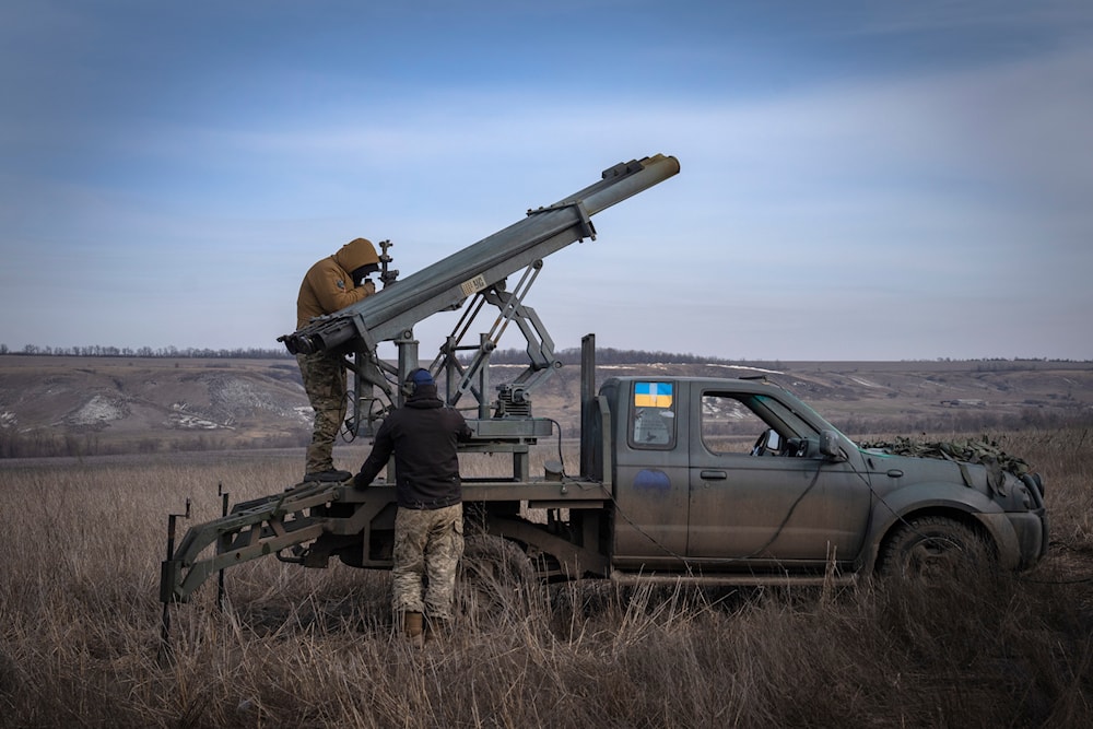 Ukrainian soldiers from The 56th Separate Motorized Infantry Mariupol Brigade prepare to fire a multiple-launch rocket system based on a pickup truck towards Russian positions at the front line, near Bakhmut, Donetsk, Russia, March 5, 2024 (AP)