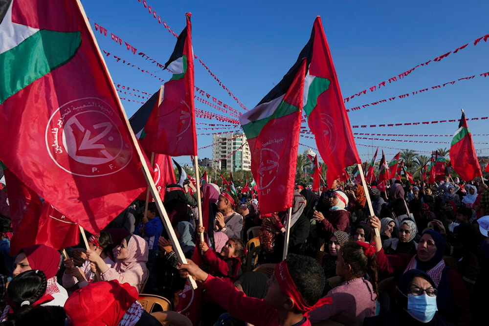 Women activists from the Popular Front for the Liberation of Palestine (PFLP)wave their national and party's red flags while marking the 55th anniversary of the PFLP, at Al Kateba Square in Gaza City, Thursday, Dec. 8, 2022. (AP)