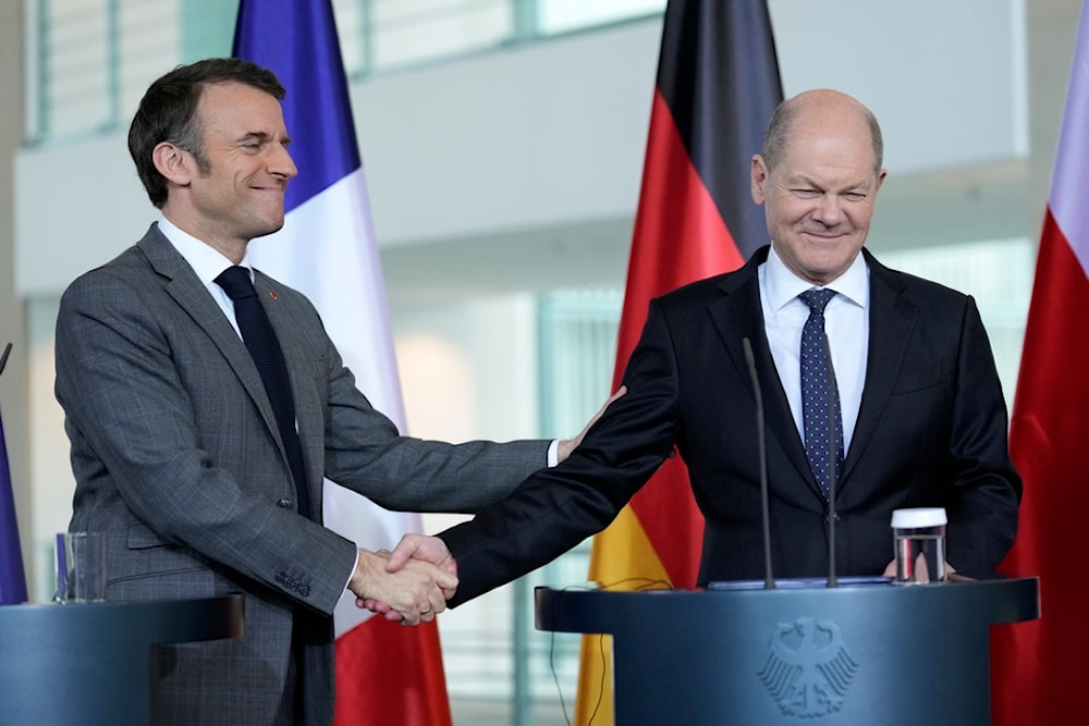 German Chancellor Olaf Scholz, right, and French President Emmanuel Macron reacts at a press conference in Berlin, Germany, Friday, March 15, 2024. (AP)