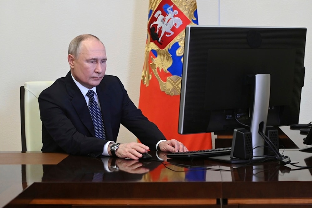 Russian President Vladimir Putin attends an electronic voting during a presidential voting at the Novo-Ogaryovo state residence outside Moscow, Russia, Friday, March 15, 2024. (AP)