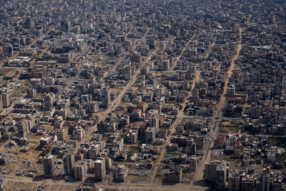 Destroyed buildings are seen through the window of an airplane from the U.S. Air Force overflying the Gaza Strip, March 14, 2024. (AP)