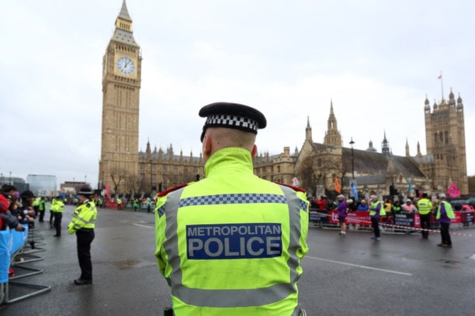 A met police officer stands in front of the Big Ben, in London, UK (AFP)