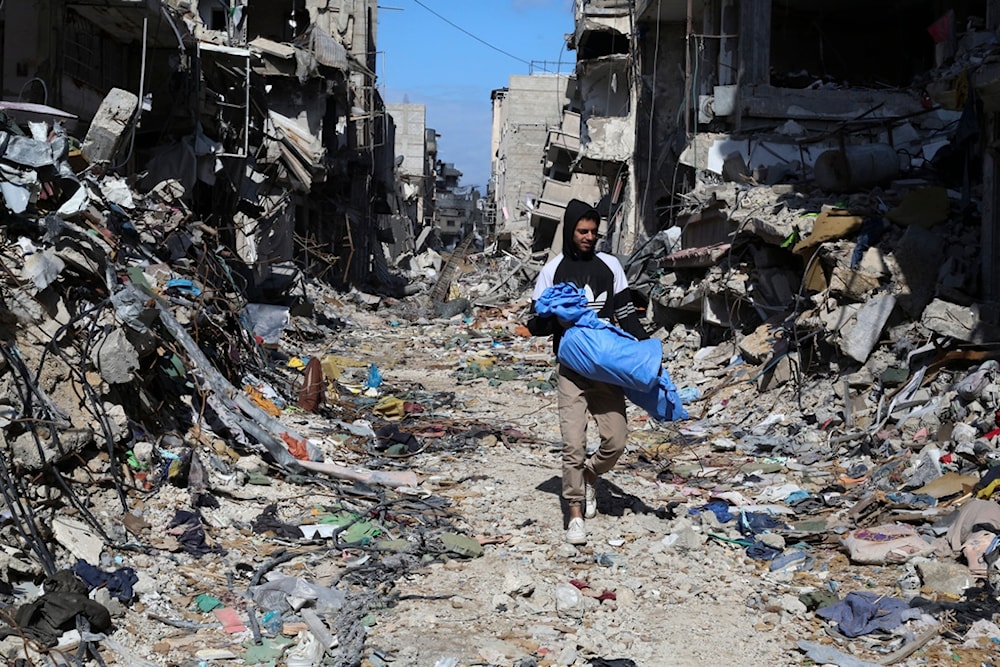 A Palestinian walks through the destruction left by the Israeli offensive on Khan Younis, Gaza Strip, Friday, March 8, 2024. (AP)