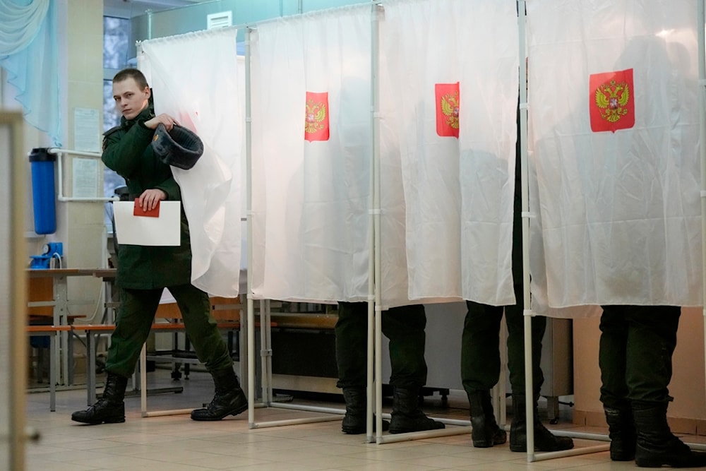 A Russian serviceman leaves a voting booth at a polling station during a presidential election in St. Petersburg, Russia, Friday, March 15, 2024 (AP)