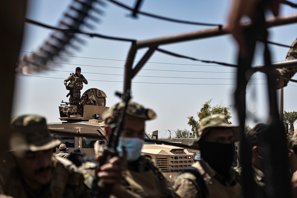 U.S.-backed Syrian Democratic Forces (SDF) militants sit on their armored vehicles, at al-Sabha town in the eastern countryside of Deir Ezzor Syria, Monday, Sept. 4, 2023.(AP)