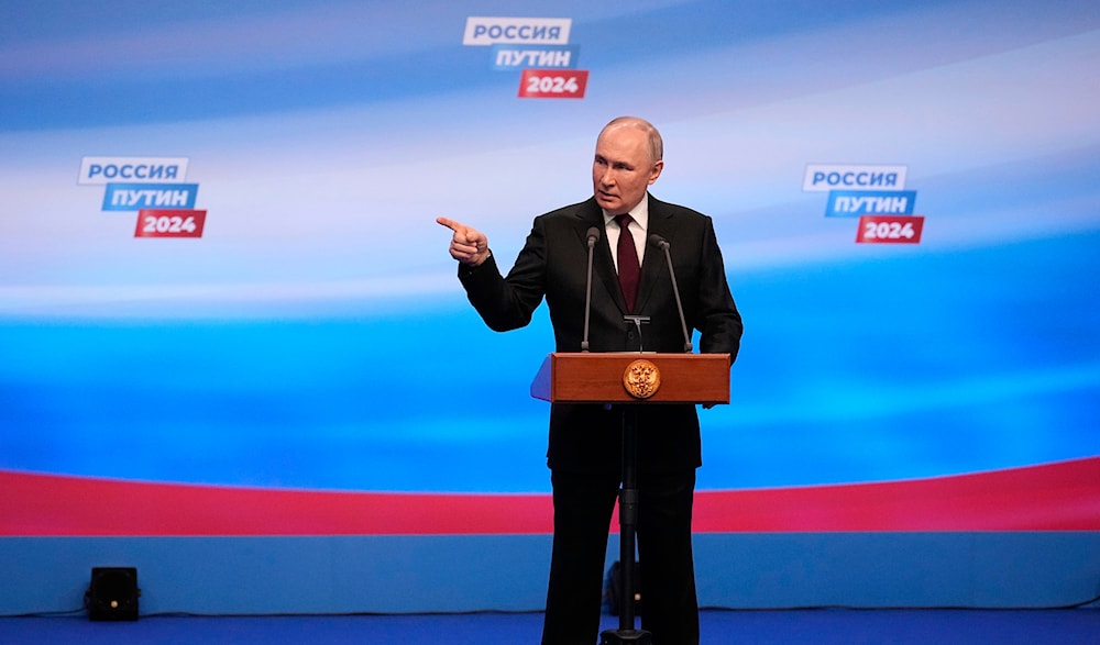 Russian President Vladimir Putin gestures while speaking on a visit to his campaign headquarters after a presidential election in Moscow, early Monday, March 18, 2024. (AP)
