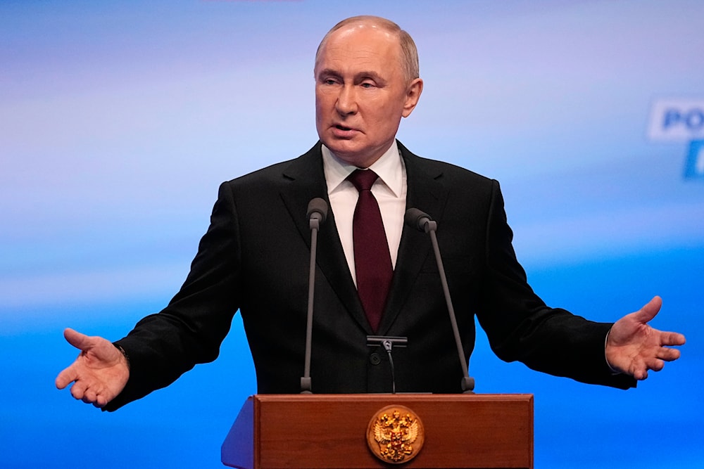 Russian President Vladimir Putin gestures while speaking on a visit to his campaign headquarters after a presidential election in Moscow, Russia, early Monday, March 18, 2024. (AP)