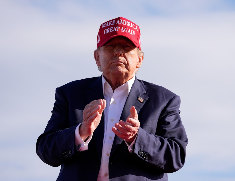 Republican presidential candidate and former President Donald Trump applauds at a campaign rally Saturday, March 16, 2024, in Vandalia, Ohio. (AP)