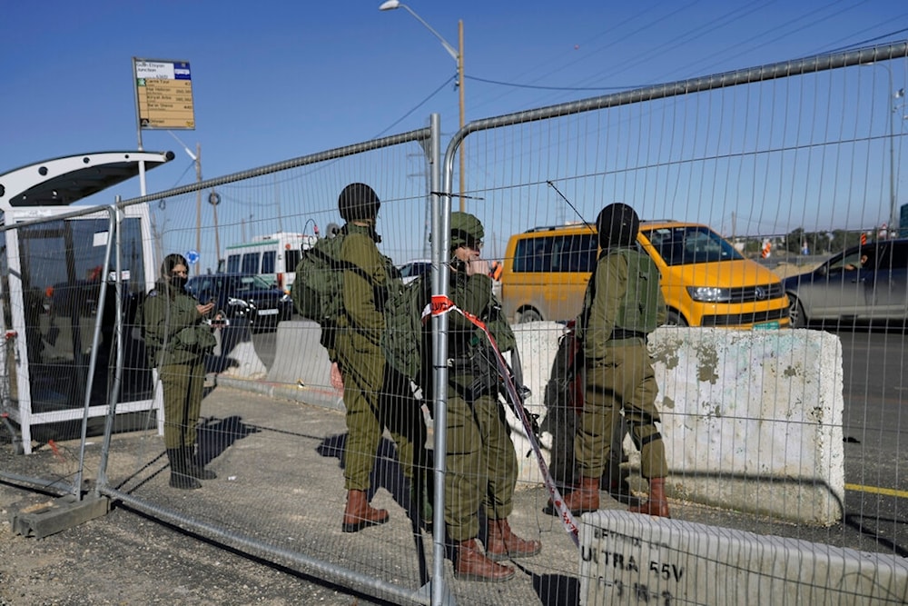 Israeli occupation soldiers stand guard at the scene of an attack in the Gush Etzion junction in the occupied West Bank, occupied Palestine, Monday, Jan. 17, 2022. (AP)