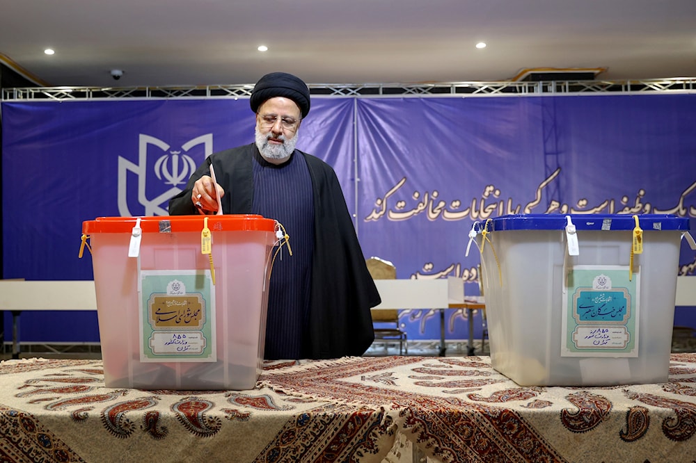 In this photo released by the official website of the Iranian presidency office, President Ebrahim Raisi casts his ballot during the parliamentary and Assembly of Experts elections in Tehran, Iran, Friday, March 1, 2024 (AP)