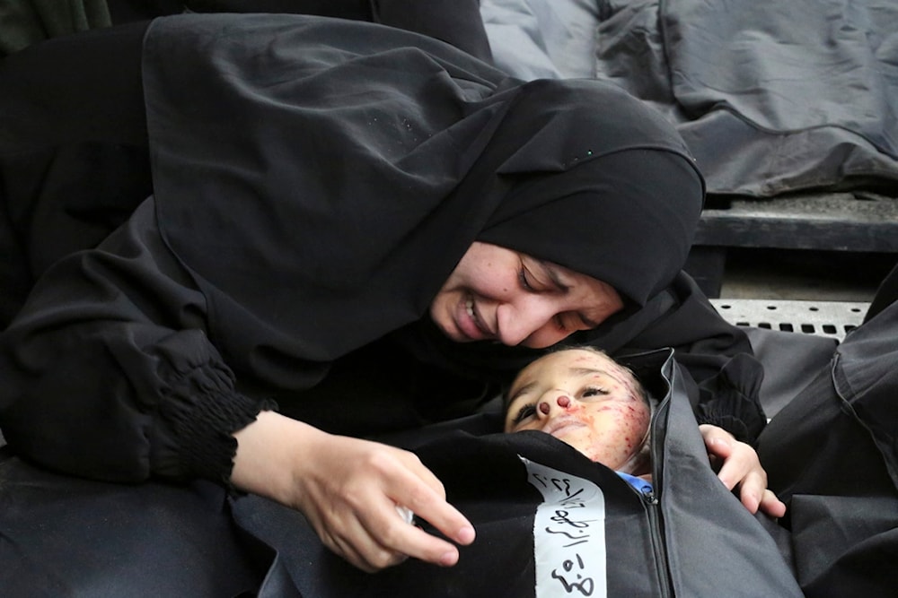 A Palestinian woman mourns a child killed in the Israeli bombardment of the Gaza Strip, occupied Palestine, at a morgue in Khan Younis, Tuesday, Feb. 27, 2024. (AP)