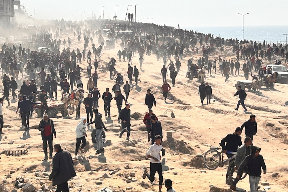 Palestinians wait for humanitarian aid on a beachfront in Gaza City, Gaza Strip, Sunday, Feb. 25, 2024. (AP)