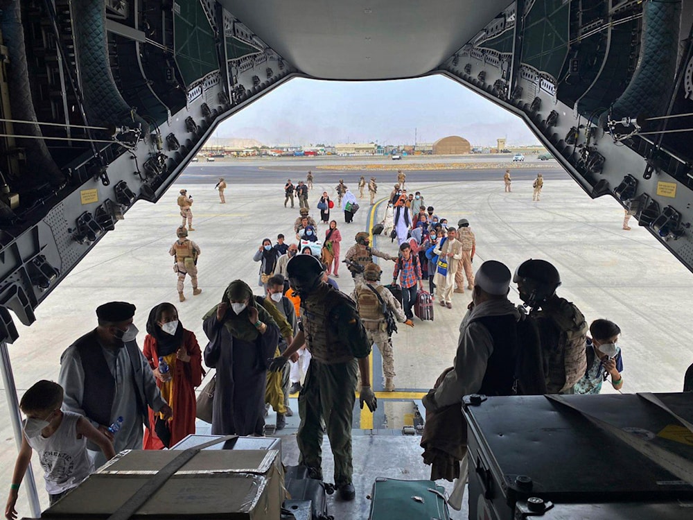 people board a Spanish airforce A400 plane as part of an evacuation plan at Kabul airport in Afghanistan, Wednesday Aug. 18, 2021. (AP)