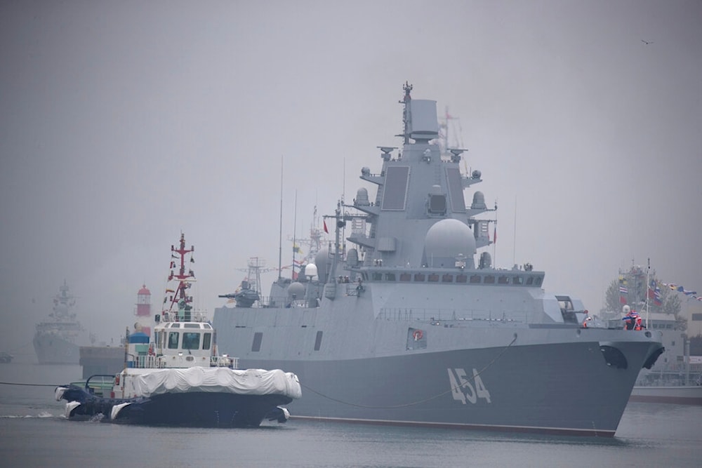 A tugboat escorts the Russian frigate Admiral Gorshkov as it prepares to dock at a port in Qingdao in eastern China's Shandong Province, Sunday, April 21, 2019. (AP)