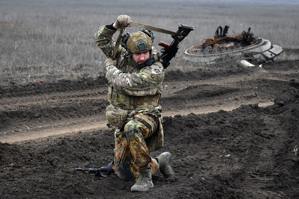 A Ukrainian soldier picks up a machine gun after a heavy fight on the front line in the village of Robotyne, Zaporizhzhia region, Ukraine, Friday, March 1, 2024. (AP)