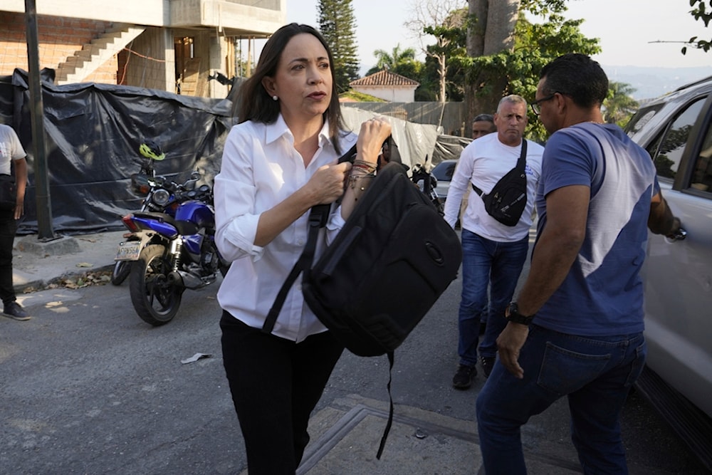 Opposition leader María Corina Machado arrives at her headquarters in order to give a press conference regarding the arrest order for her campaign manager and eight other opposition members, March 20, 2024 (AP)