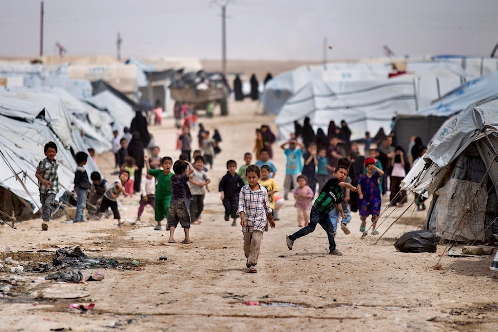 Children gather outside their tents at the al-Hol camp, which houses families of members of the Islamic State group, in Hasakeh province, Syria, on May 1, 2021 (AP)