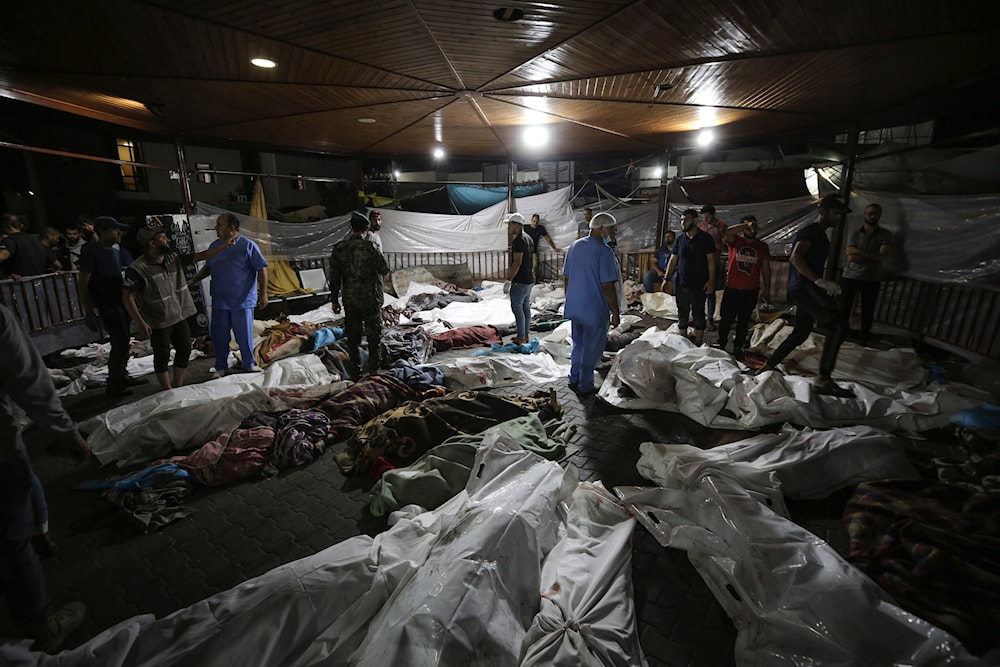 Bodies of Palestinians killed by IOF bombing Al-Ahli Arab Hospital are gathered in the front yard of the al-Shifa hospital, in Gaza City, central Gaza Strip, Tuesday, Oct. 17, 2023. (AP)