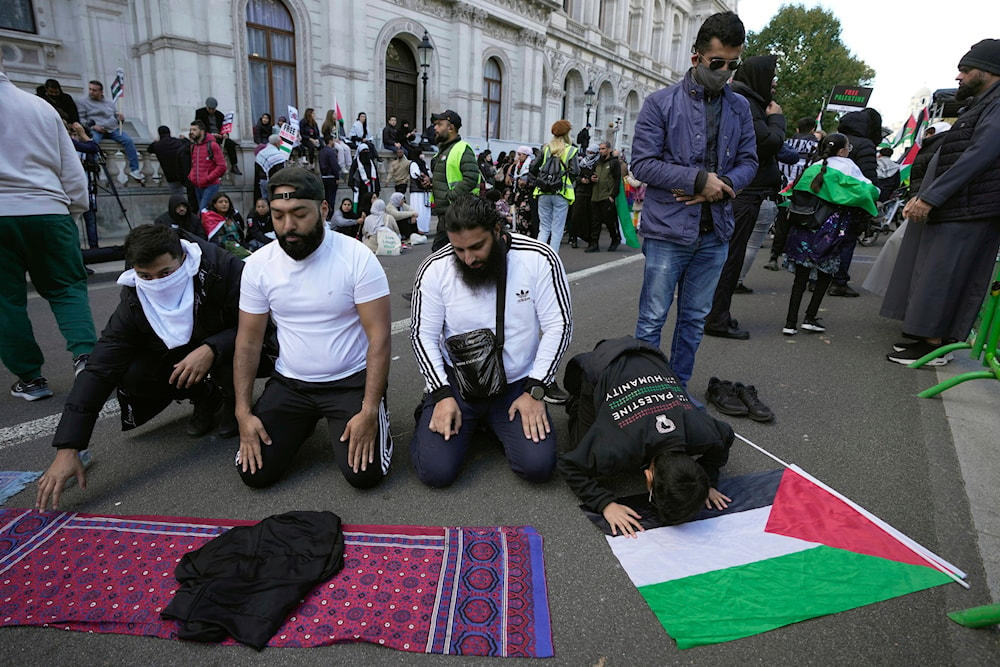 Protesters pray during a pro-Palestinian demonstration in London, Saturday, Oct. 14, 2023.(AP)