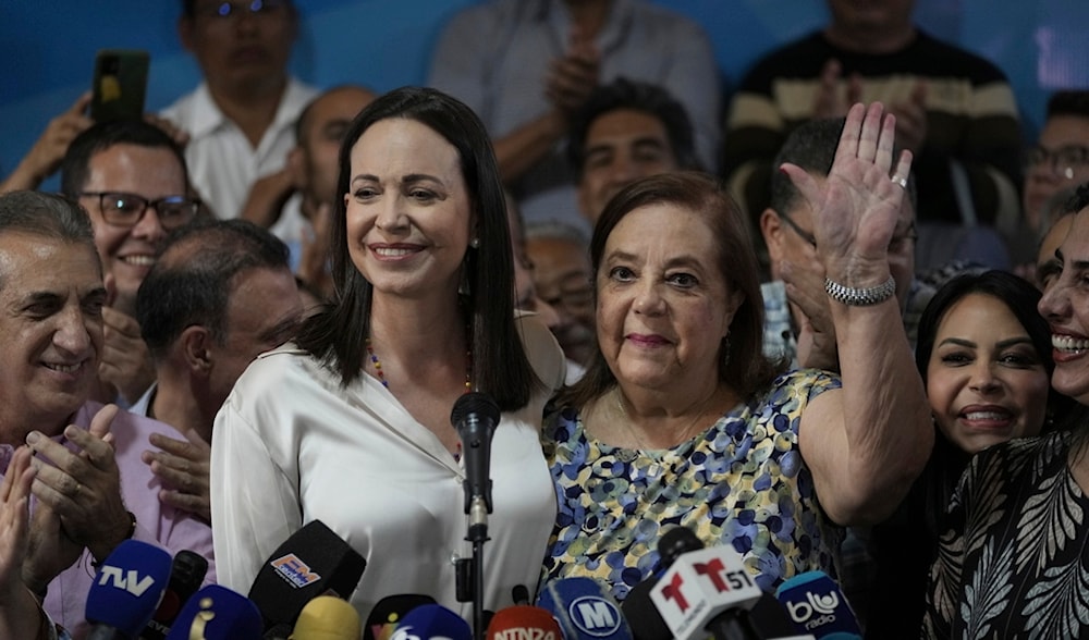 Opposition leader María Corina Machado holds a press conference accompanied by Corina Yoris, in Caracas, Venezuela, Friday, March 22, 2024. (AP)