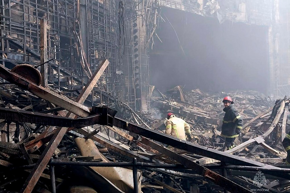 In this photo released by Russian Emergency Ministry Press Service on March 23, 2024, firefighters work in the burned concert hall after an attack on the building of the Crocus City Hall on the western edge of Moscow, Russia (AP)