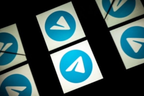 Telegram icons are seen on a black screen. (AFP)