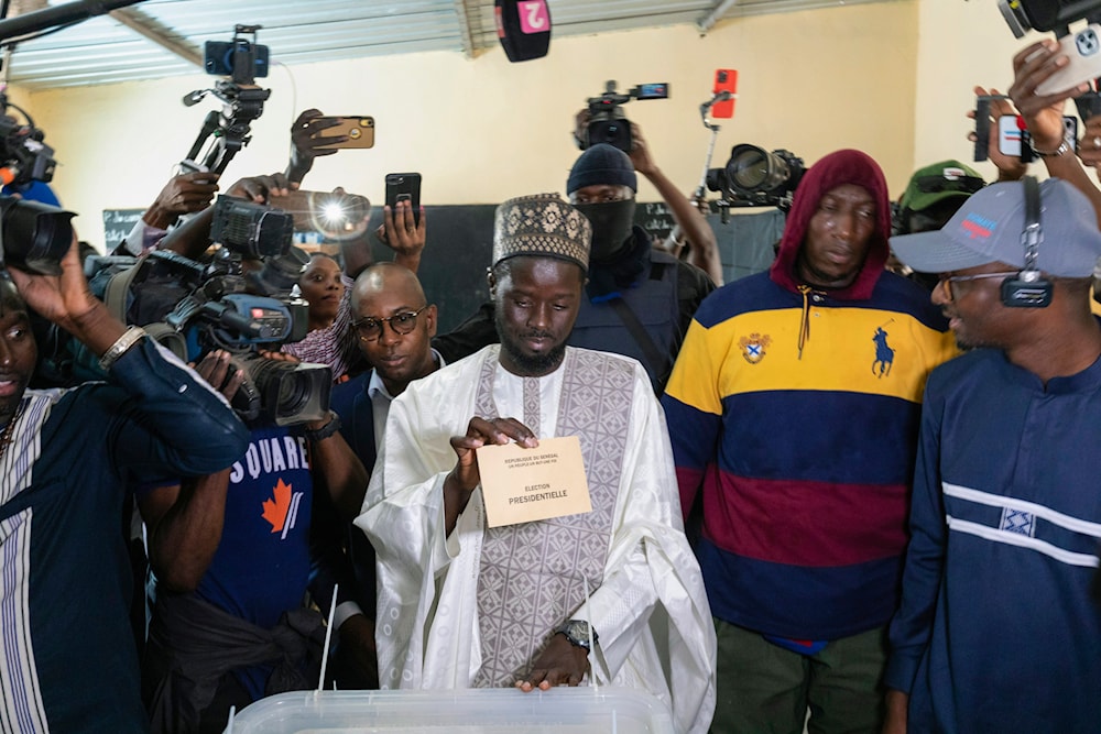 Senegalese opposition candidate Bassirou Diomaye Faye casts his ballot for the presidential elections, in Ndiaganiao, Senegal, March 24, 2024. (AP)