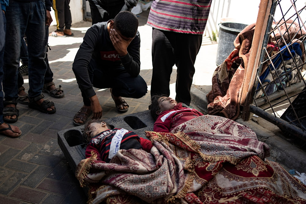 Palestinians mourn relatives killed in the Israeli bombardment of the Gaza Strip at a hospital morgue in Rafah, Wednesday, March 20, 2024. (AP)