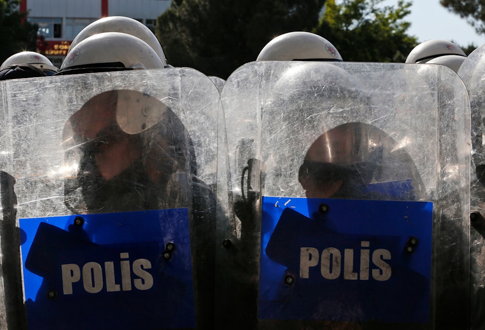 Turkish police officers stand guard during clashes with anti-government protesters in Soma, Turkey where the mine accident took place, Friday, May 16, 2014. (AP)