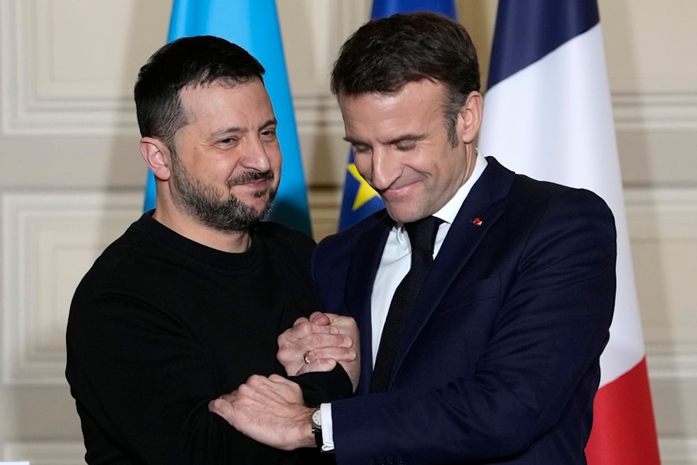 Ukrainian President Volodymyr Zelenskyy, left, and French President Emmanuel Macron shake hands after a press conference, on Feb. 16, 2024 at the Elysee Palace in Paris. (AP)