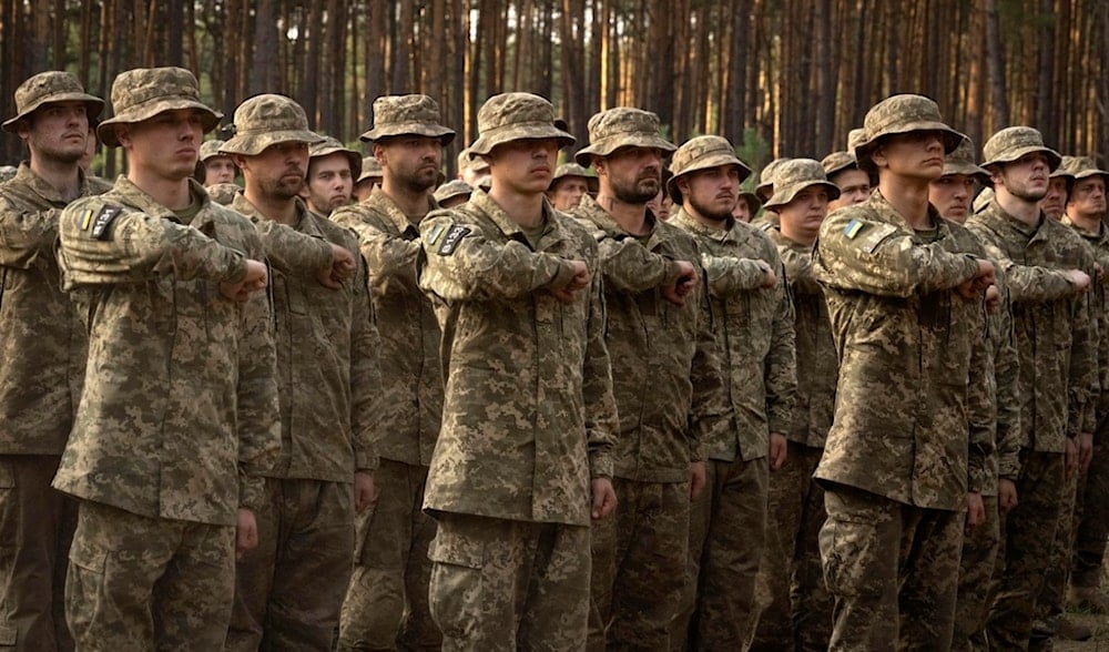 Newly recruited soldiers of Ukraine's 3rd Assault Brigade shout slogans at a military base close to Kiev, Ukraine, Monday, Sept. 25, 2023 (AP)
