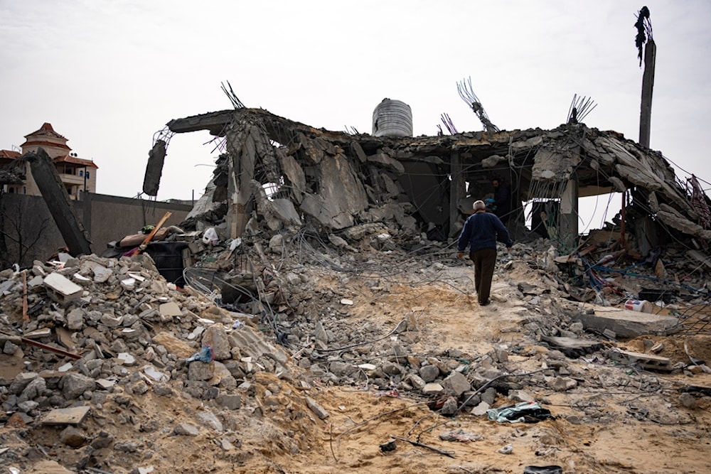 Palestinians look at a house destroyed in an Israeli strike in Rafah, Gaza Strip on Tuesday, March 26, 2024 (AP Photo/Fatima Shbair)