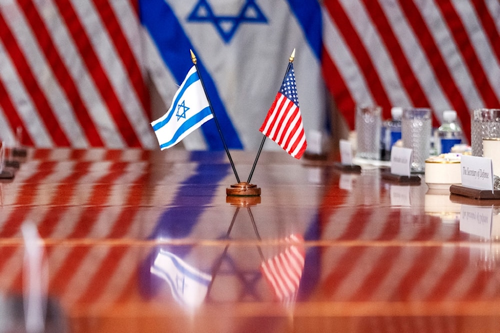 An Israeli and US flag are reflected on a conference table as Defense Secretary Lloyd Austin meets with Israeli Security Minister Yoav Gallant, at the Pentagon, March 26, 2024, in Washington. (AP)