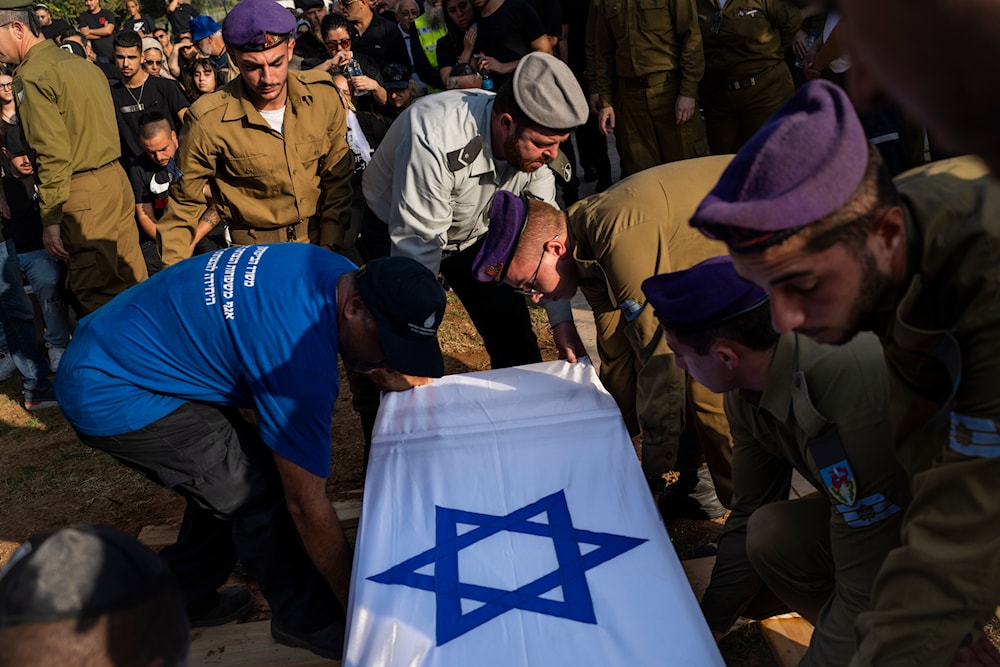 Israeli occupation troops lower the coffin of Israeli Staff Sergeant Shay Arvas at a cemetery outskirts of 'Tel Aviv', occupied Palestine, Thursday, Nov. 2, 2023.(AP)